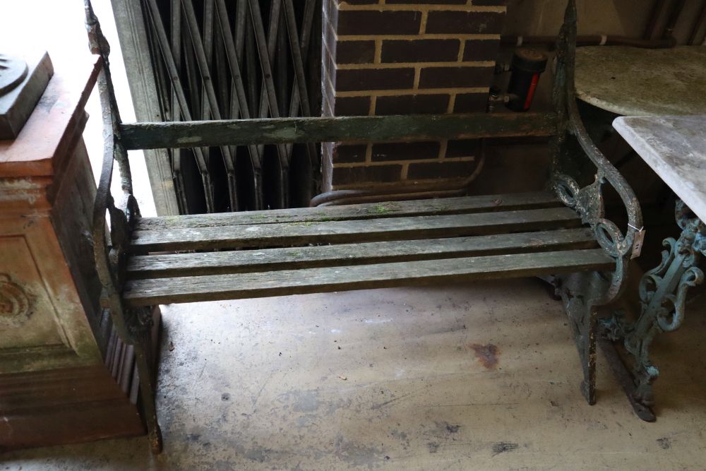 A Victorian painted cast iron slatted garden bench, width 126cm together with two cast iron marble top garden tables